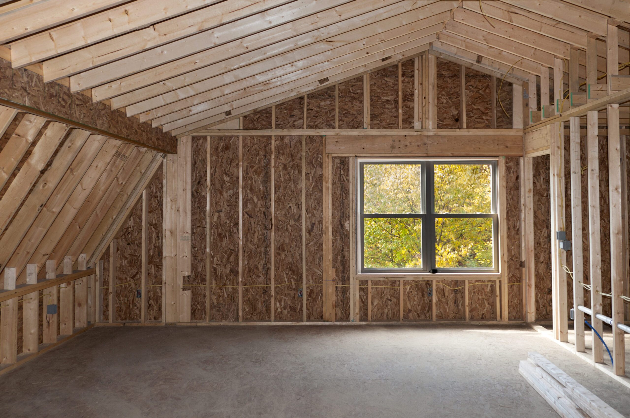 Room,Addition,Construction,With,Pitched,Ceiling,And,Autumn,Trees,View